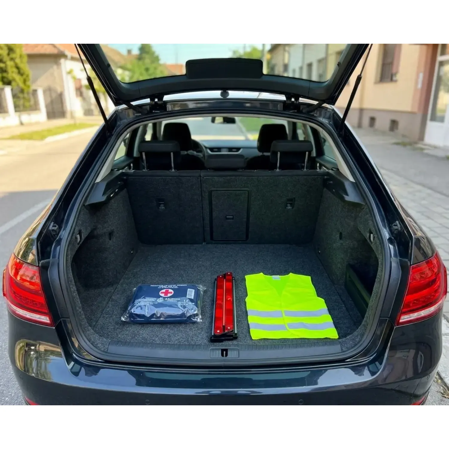 Komplet prve pomoći za auto, sigurnosni trougao i reflektujući prsluk u gepeku automobila